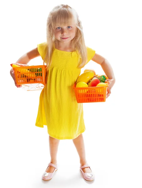 Girl in a yellow dress with vegetables — Stock Photo, Image