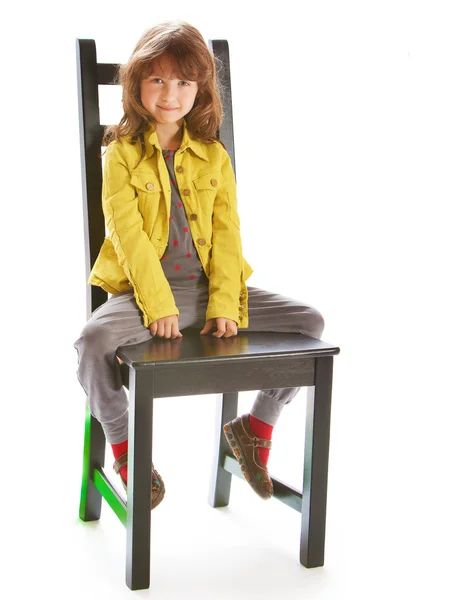 Beautiful girl sitting on a chair — Stock Photo, Image