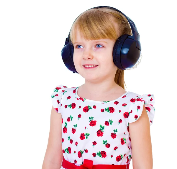 Very musical little girl having fun listening to music through t — Stock Photo, Image