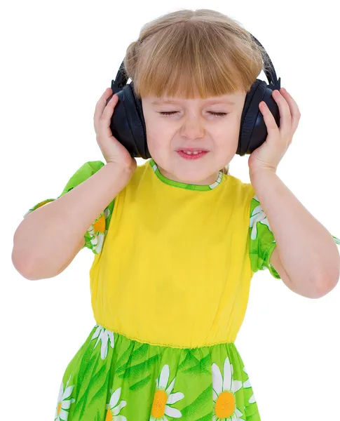 Very musical little girl having fun listening to music through t — Stock Photo, Image