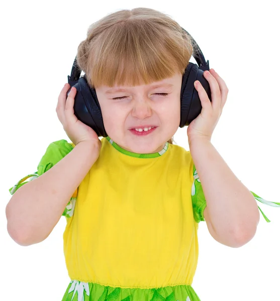 Very musical little girl having fun listening to music through t — Stock Photo, Image