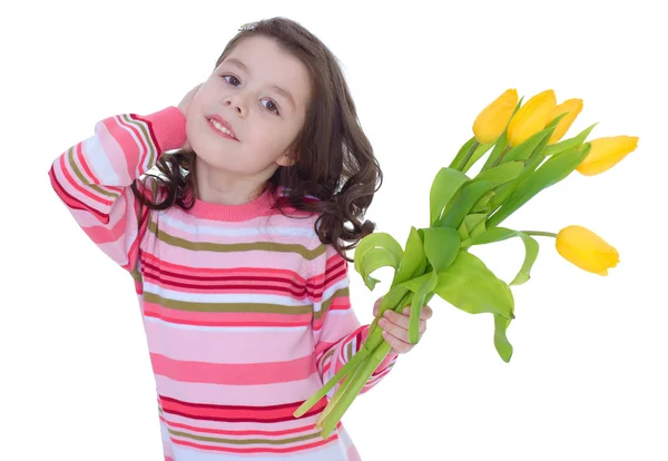 Charming little girl with yellow tulips. — Stock Photo, Image