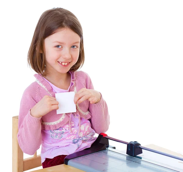 Little girl is cutting paper — Stock Photo, Image