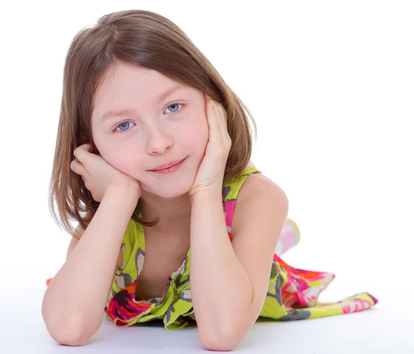 Charming young girl lying on the floor and smiling. — Stock Photo, Image