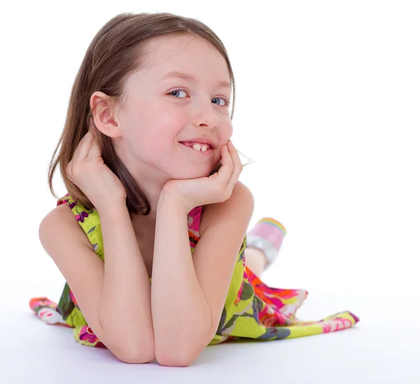 Charming young girl lying on the floor and smiling. — Stock Photo, Image