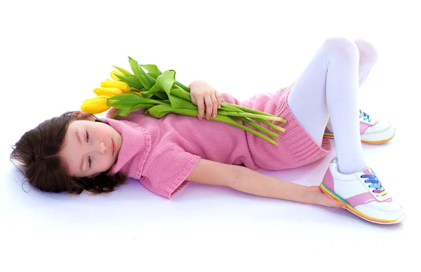 Little girl with beautiful flowers. — Stock Photo, Image