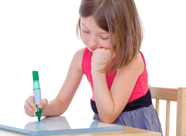 Girl schoolgirl sits at a table — Stock Photo, Image