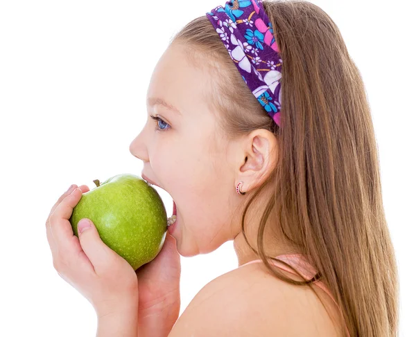 Charming little girl with green apple. — Stock fotografie