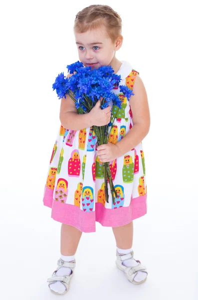 Little girl with blue flowers — Stock Photo, Image