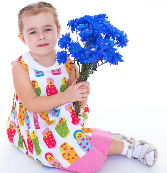 Little girl with blue flowers — Stock Photo, Image