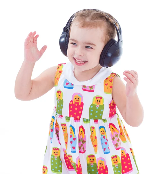 Krásná roztomilá šťastná holčička se sluchátky — Stock fotografie