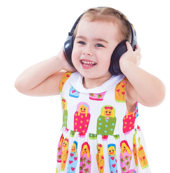 Vacker söt glad liten flicka med hörlurar — Stockfoto
