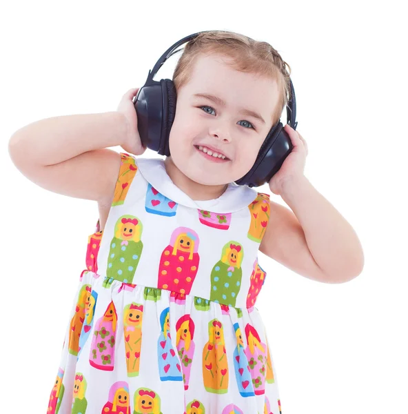 Krásná roztomilá šťastná holčička se sluchátky — Stock fotografie