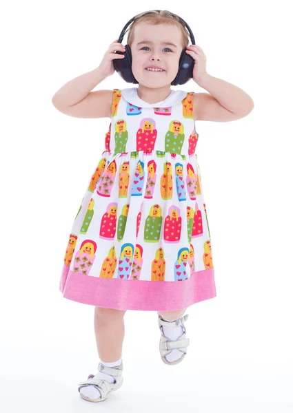 Mooi schattig gelukkig klein meisje met hoofdtelefoon — Stockfoto