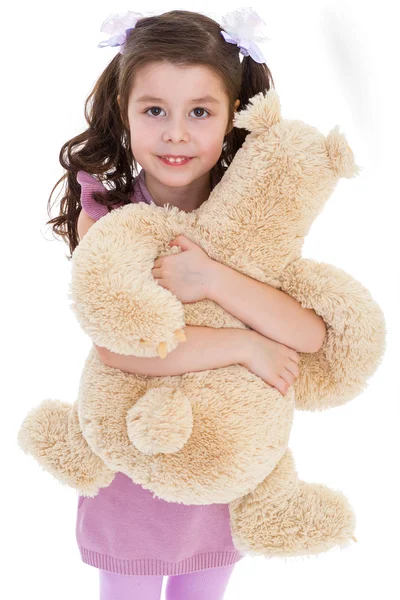 Girl hugging her teddy bear. — Stock Photo, Image