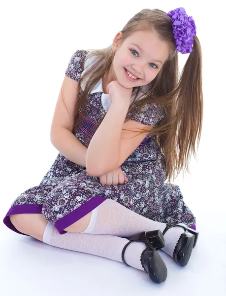 Charming little girl sitting on the floor. — Stock Photo, Image