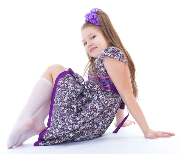 Charming little girl sitting on the floor. — Stock Photo, Image