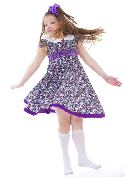 Girl jumping spinning and waving hands — Stock Photo, Image