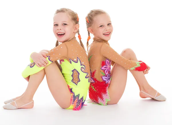 Adorable twin girls gymnasts. — Stock Photo, Image