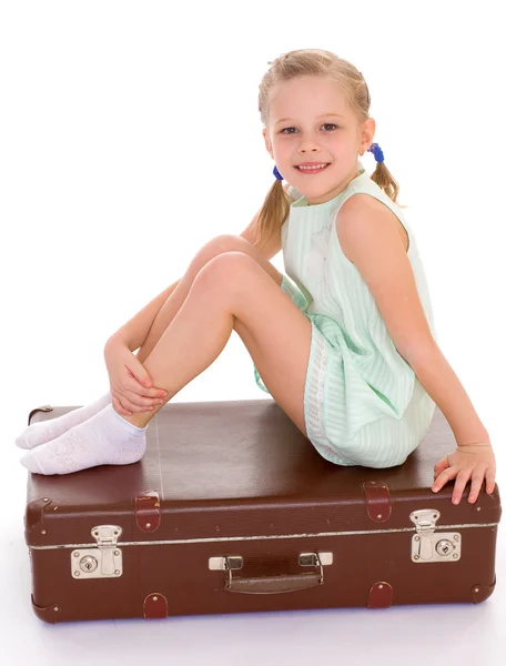 Little girl with a big and very old suitcase. — Stock Photo, Image