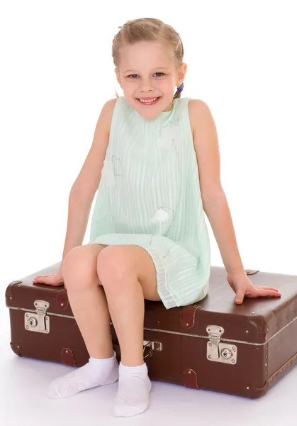 Little girl with a big and very old suitcase. — Stock Photo, Image