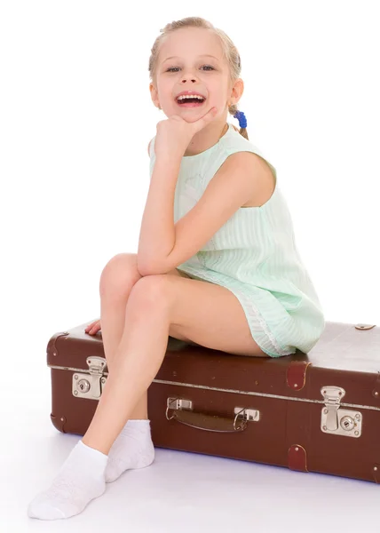 Little girl with a big and very old suitcase. — Stock Photo, Image