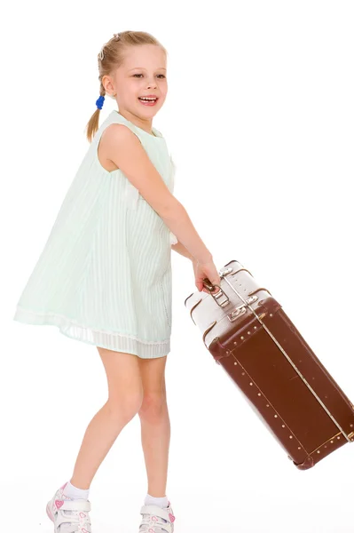 Little girl with a big and very old suitcase. — Stock Photo, Image