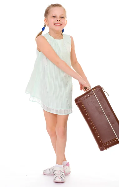 Little girl with a big and very old suitcase. — Stock Photo, Image