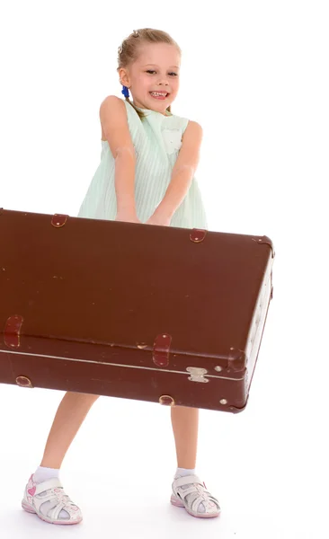 Little girl with a big and very old suitcase. — Stock Photo, Image