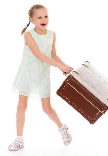 Little girl with a big and very old suitcase. — Stock Photo, Image