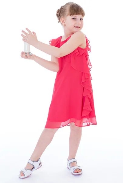 Cute little girl is holding big glass of milk — Stock Photo, Image