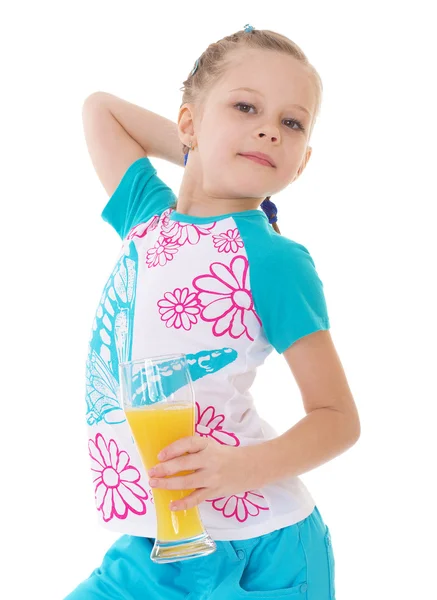 Cute little girl drinks orange juice — Stock Photo, Image