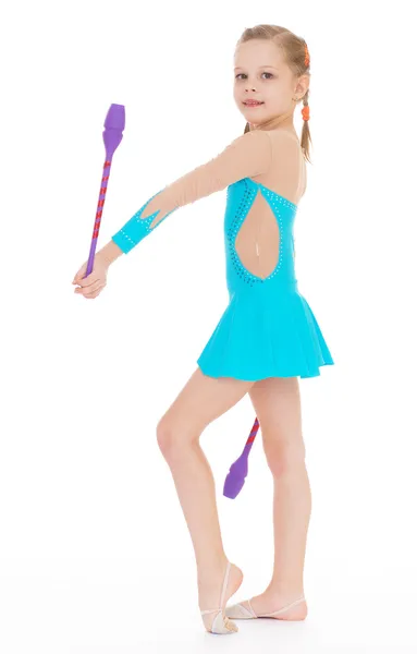 Cute girl gymnast with sports maces. — Stock Photo, Image