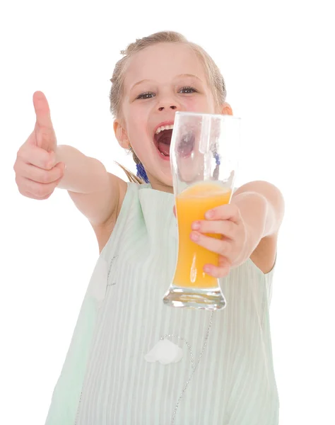 Cute little girl drinks orange juice — Stock Photo, Image