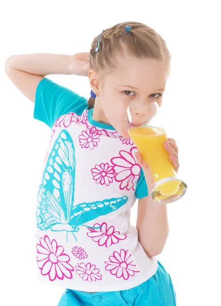 Cute little girl drinks orange juice — Stock Photo, Image