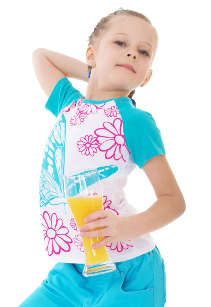 Cute little girl drinks orange juice — Stock Photo, Image