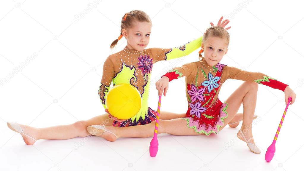 Two pretty little girl doing gymnastics
