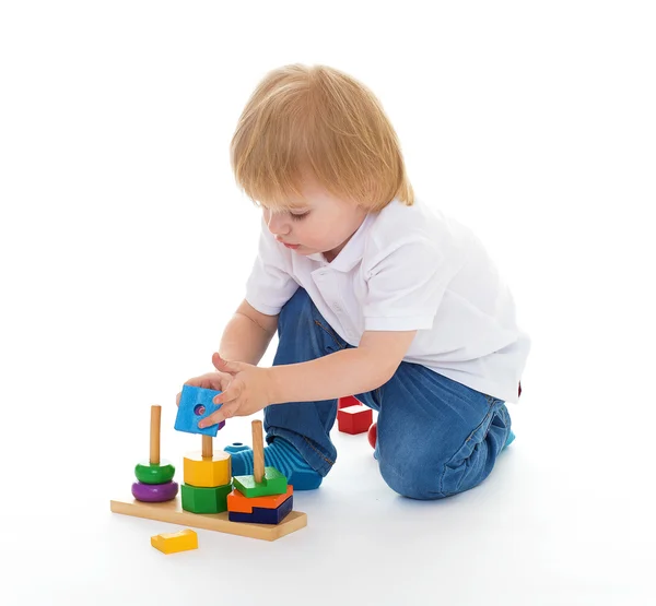 Little boy in the classroom at Montessori environment. Royalty Free Stock Images