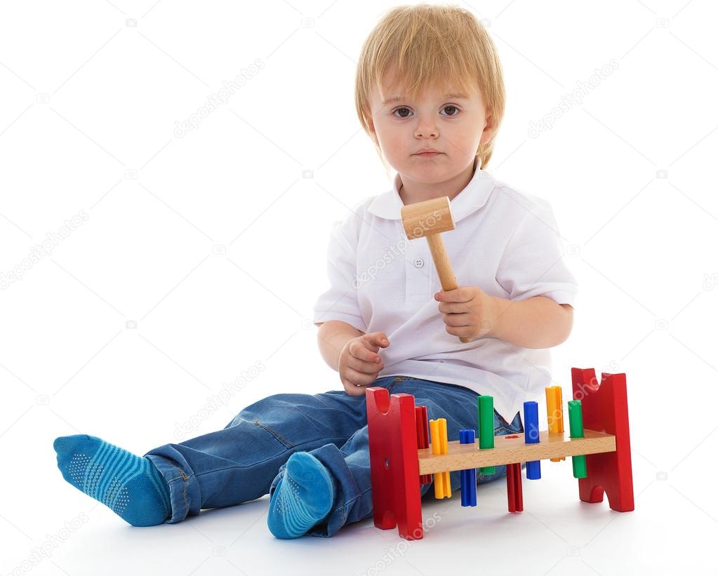 little boy in the classroom at Montessori environment.