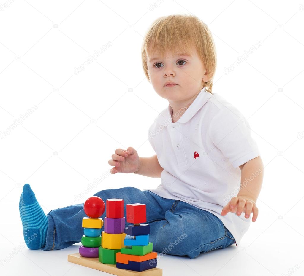 little boy in the classroom at Montessori environment.