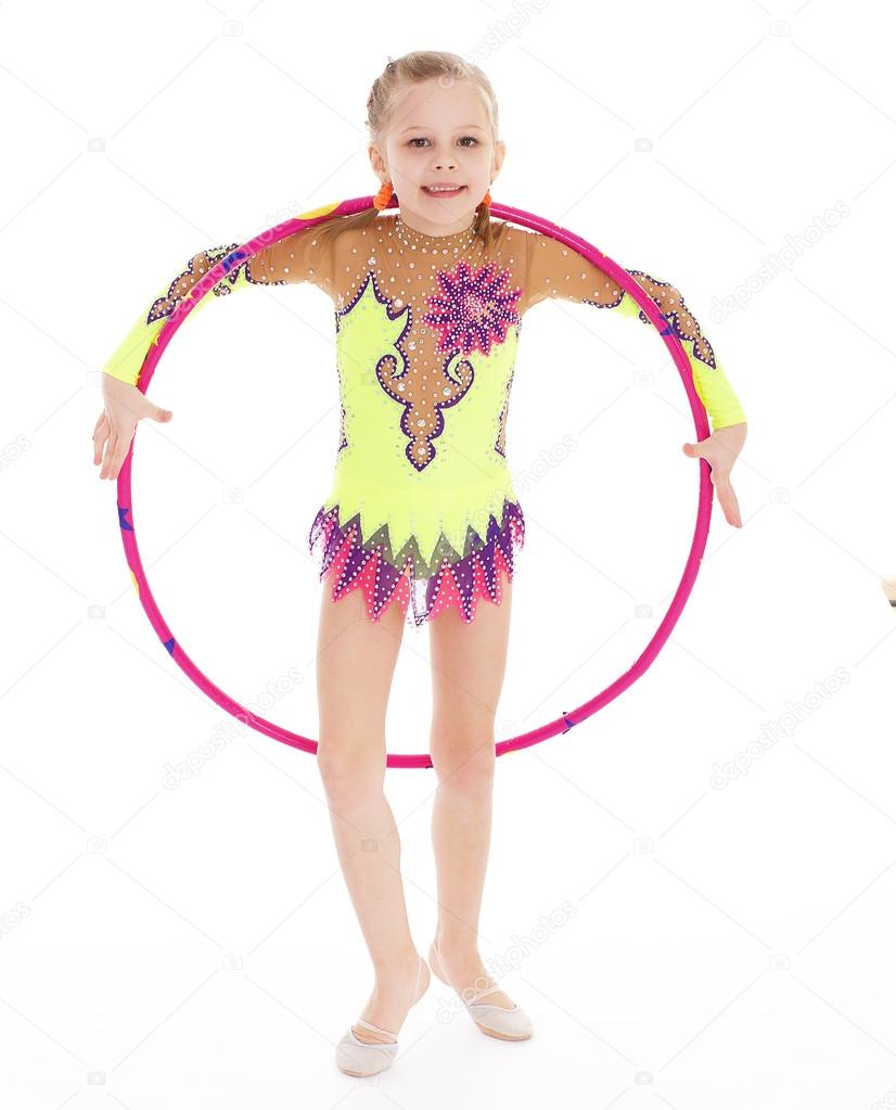 Beautiful little gymnast with the hoop