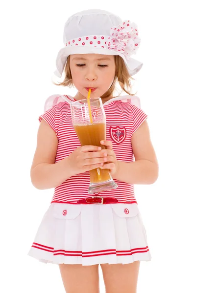 Charming little girl with a glass of juice. — Stock Photo, Image