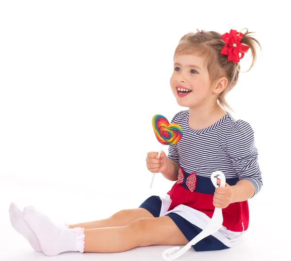 Charming little girl with a lollipop. — Stock Photo, Image