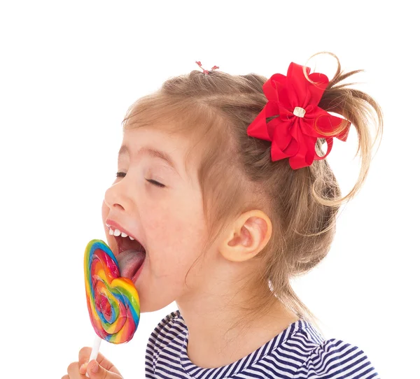 Charming little girl with a lollipop. — Stock Photo, Image