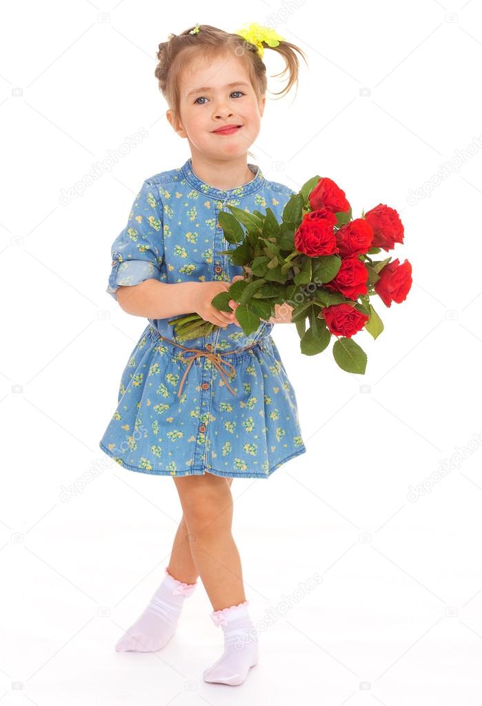 charming little girl holding a bouquet of red roses.