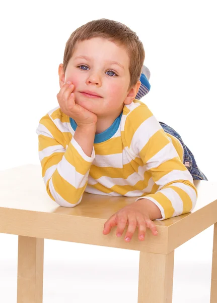 Маленький мальчик играет за столом — стоковое фото
