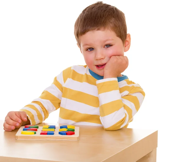 Menino brincando na mesa — Fotografia de Stock