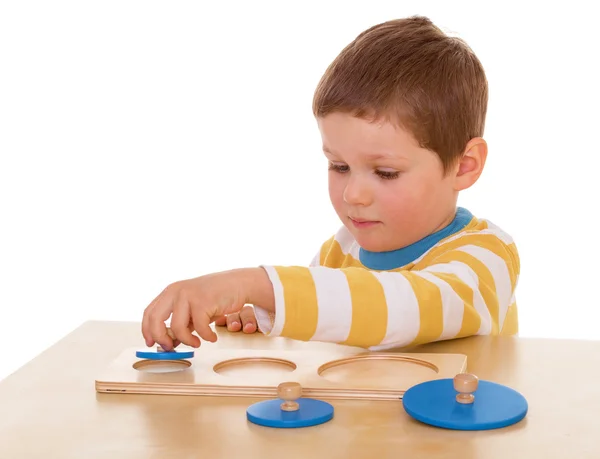 Little boy playing at the table — Stok fotoğraf