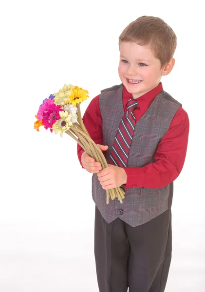 Little boy with flowers. — Stock Photo, Image