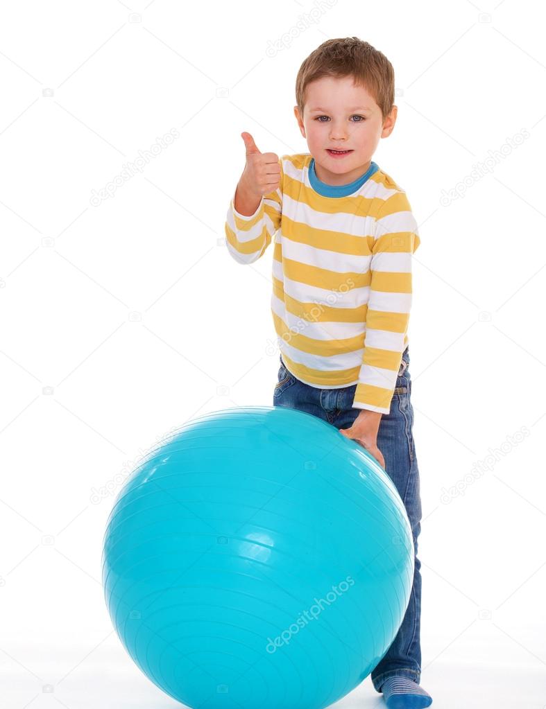 Little boy with a big ball.